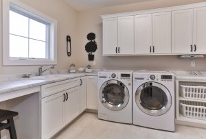 Laundry Room cabinetry with sink under window